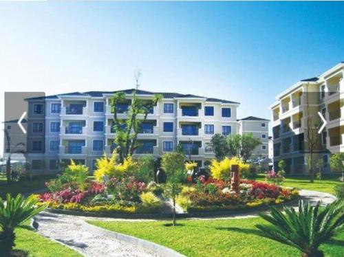 an apartment building with a garden in front of it at Cedar Fourways Sandton in Trevallyn