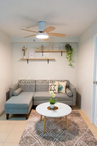 a living room with a couch and a table at 2 BR Unit in the heart of Iloilo Self Check-in in Iloilo City