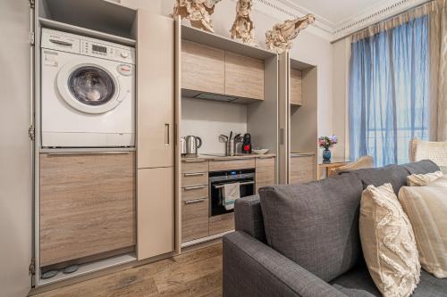 a living room with a couch and a washer and dryer at Stay Trafalgar Square in London