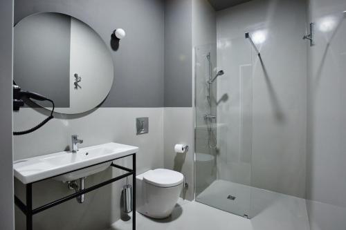a bathroom with a shower and a sink and a toilet at Cukrownia Żnin in Żnin
