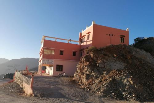 a building on top of a hill with a large rock at Hotel la belle vue 2100m in Taroudant