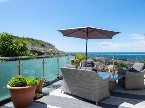 a patio with chairs and an umbrella on a balcony at BnB-side in Portland
