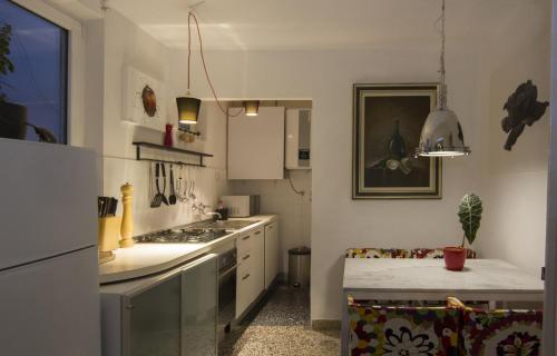 a kitchen with a refrigerator and a stove top oven at Art Apartment in Rovinj
