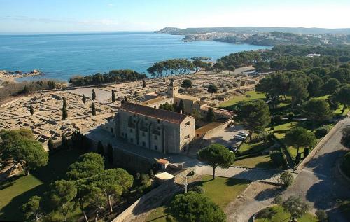 an aerial view of a building next to the ocean at Villa Montgó in L'Escala