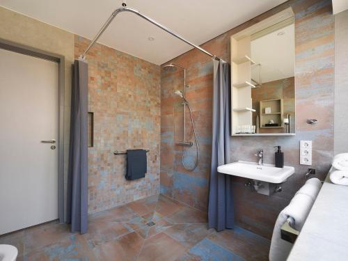a bathroom with a shower and a sink at Das Neue CAPITOL in Bad Berleburg