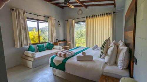 a bedroom with two beds and a large window at Misty Villa Powered by TSC in Pussellawa