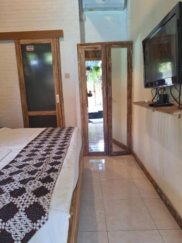 Cama o camas de una habitación en Oma Joglo Jimbaran
