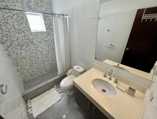 a bathroom with a sink and a toilet and a mirror at Elegant 1Bed Duplex in Lima