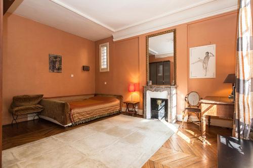 a living room with a bed and a fireplace at Hôtel Particulier - Palais des Congrès in Neuilly-sur-Seine