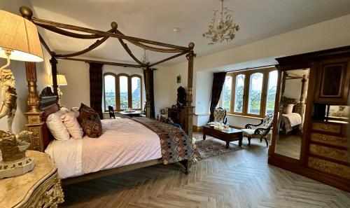 a bedroom with a canopy bed and a mirror at Claregalway Castle in Claregalway