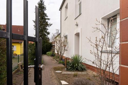 an open door to a garden outside a house at Rosewood - Apartment by Comfort Housing in Falkensee