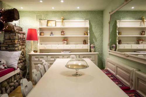 a dining room with a table with a glass bowl on it at La Contrada B&B in Casnate con Bernate