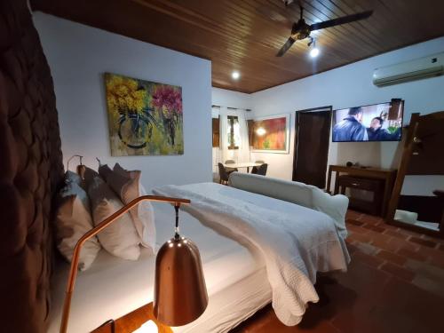 a bedroom with a bed and a lamp in it at Hotel Boutique Casa de Los Santos Reyes Valledupar in Valledupar