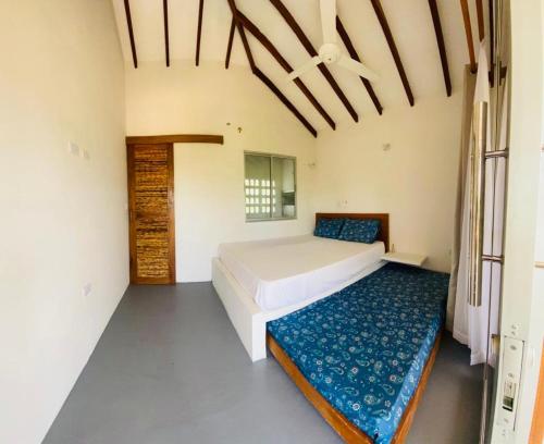 a bedroom with two beds in a room at Cabaña cerca al Mar con Pisicina y AC en Tolú in Tolú