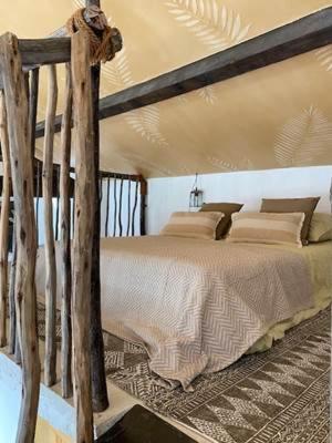 a bedroom with a wooden bed in a room at Le Mas des Perrines Maison d’Hôtes in Pernes-les-Fontaines