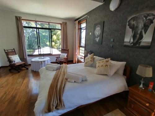 a bedroom with a large bed with white sheets at Florances Rest House in Nairobi
