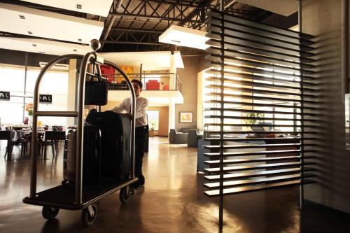 a man standing in a room with a cart at Epic Hotel San Luis in La Punta