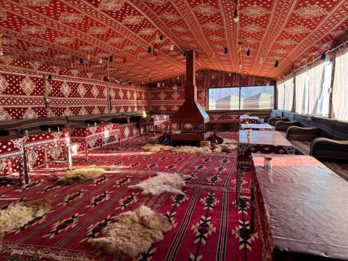 a large room with sheep on a red carpet at Desert Bird Camp in Wadi Rum