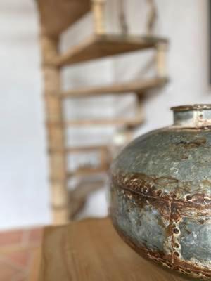 a vase sitting on top of a wooden table at Le Mas des Perrines Maison d’Hôtes in Pernes-les-Fontaines