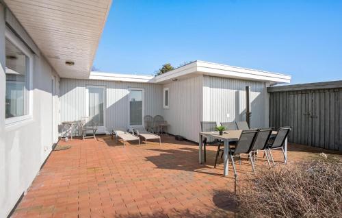 a patio with a table and chairs on a house at Gorgeous Home In Assens With Kitchen in Assens