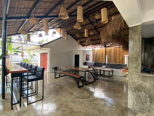 a dining room with a table and chairs at Wild Monkeys Hostel in Moalboal