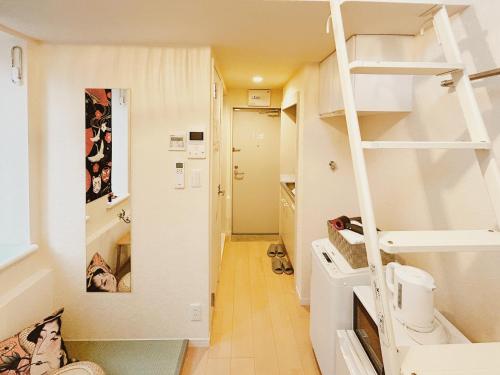 a small room with a bunk bed and a ladder at Kichijoji Loft Apartment close to JR Chuo Line 12mins to Shinjuku in Kichijōji