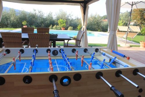 a ping pong table with paddles in the middle at B&B La Grola in San Martino Buon Albergo