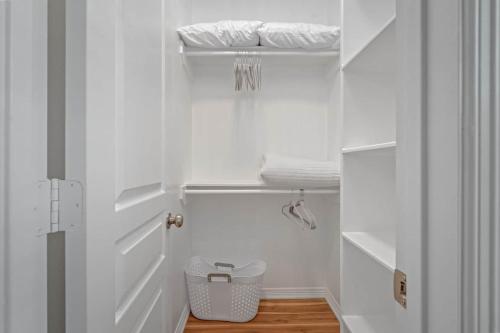 a small bathroom with white walls and a white door at Studio Heightspets! Walk To Restaurants in Houston
