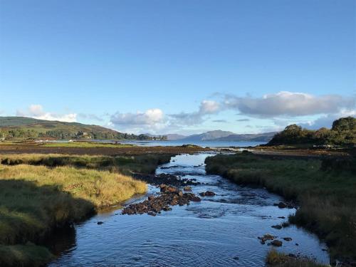 a river in the middle of a field at Argyll House Burnside in Salen