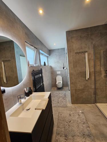 a bathroom with a sink and a shower at Casa33 in Bornem