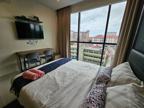 a hotel room with a bed and a large window at Kuching Kozi Square 2paxs Large Window CityView Infinity Pool 2E in Kuching