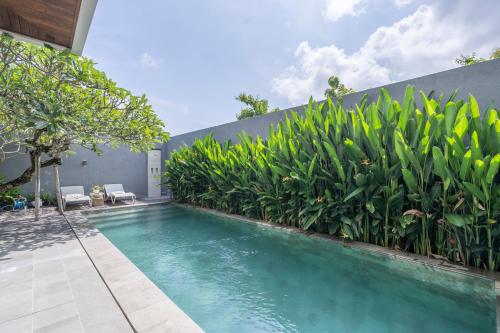 a swimming pool in the backyard of a house at Villa Days Bali in Jimbaran