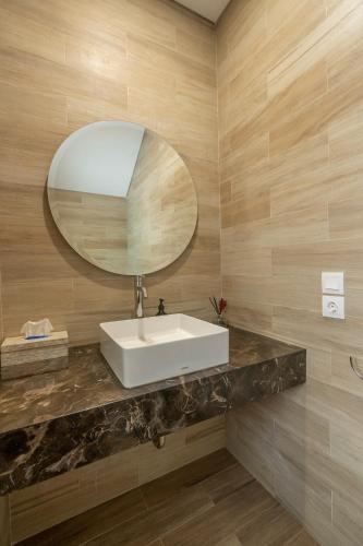 a bathroom with a sink and a mirror at Villa Days Bali in Jimbaran