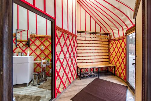a room with a bench and a sink in a room at Karkyra Yurt Glamping in Sarytëbë