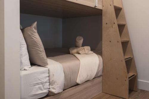 a bed in a room with a loft bed at On The Rocks Ski in Ski out Spa in Saint Come