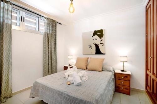 a bedroom with a bed with a stuffed animal on it at Ático Los Seres in Los Cristianos