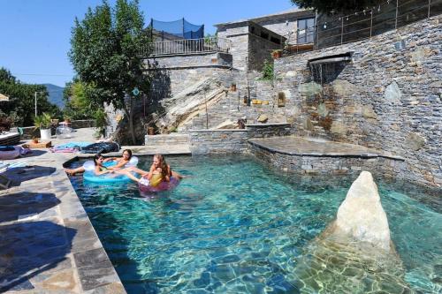 a group of people in a pool at a water park at Jolie maison avec piscine près d'un village typique in Monte