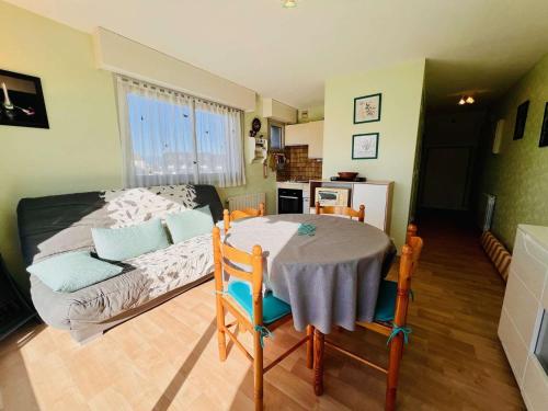 Cette chambre comprend une table, un lit et une cuisine. dans l'établissement Studio lumineux avec coin nuit, balcon, parking, animaux acceptés - Quiberon - FR-1-478-122, à Quiberon