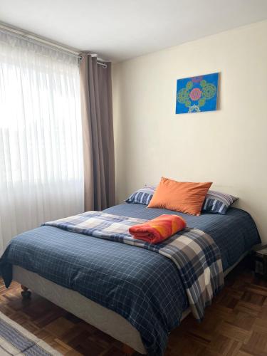 a bed with two pillows on it in a bedroom at Departamento acogedor en la mejor zona de La Paz in La Paz