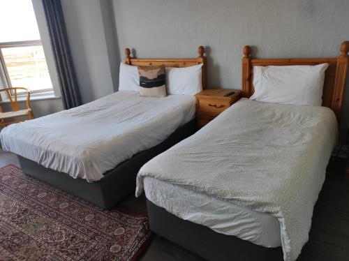 two beds sitting next to each other in a room at 4 Bayview terrace in Bundoran