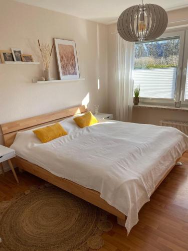 a bedroom with a large bed with two yellow pillows at Ferienwohnung Idylle auf Fehmarn I in Vitzdorf