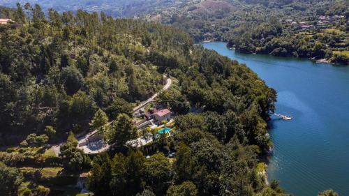 an aerial view of a house on a island in a lake at Casa da Cascata in Geres