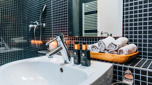a bathroom with a sink and a basket of towels at Casa da Cascata in Geres
