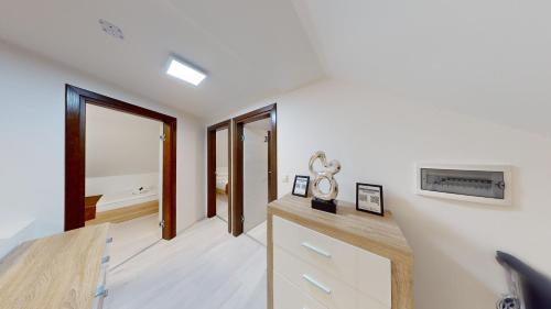 a room with white walls and a desk with a mirror at Villa Four Stars ART-PE in Trebnje