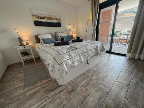 a bedroom with a bed and a large window at Paz Ocean View, Air condition, Wifi, Heated pool in San Miguel de Abona