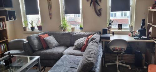 a living room with a couch and a desk at 1 Bedroom Flat 27 Mins to London Victoria in Sydenham