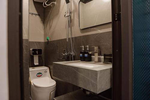 a bathroom with a sink and a toilet at Halidao Homestay in Hai Phong