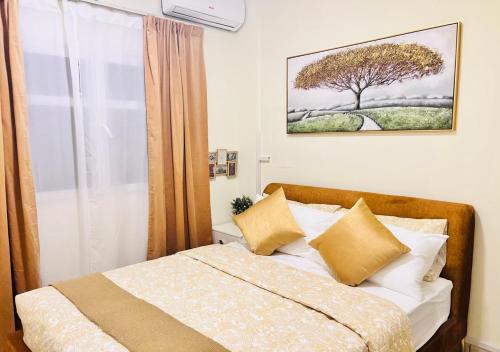 a bedroom with a bed and a window with a tree at STA Homes Dubai in Dubai