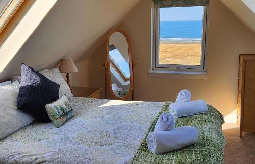 a bedroom with a bed with towels on it at Solas Alainn Chalet in Portree