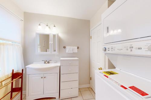 a white bathroom with a sink and a stove at Town of Rehoboth Beach - 50A Olive Ave in Rehoboth Beach